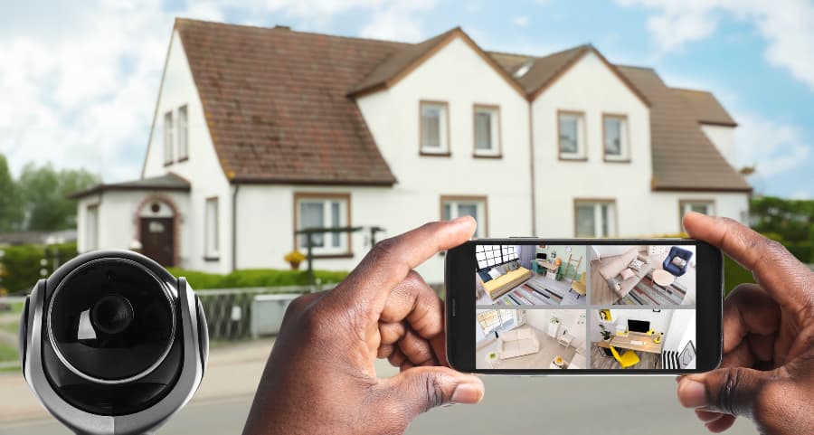 Man holding smartphone and viewing streams from video cameras